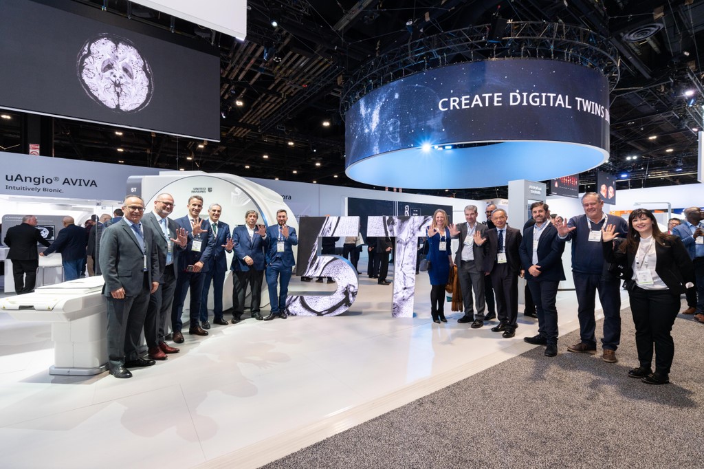 Teams from HT Medica, APR Spain and United Imaging Healthcare Europe in front of the Jupiter 5 Telsa MRI mockup during RSNA 2025. 
